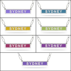 Seven necklaces with rectangular pendants featuring the name \“Sydney\“ in various colors: purple, blue, yellow, green, pink, and two shades of purple.