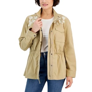 A khaki-colored jacket with cinched waist and floral embroidery on the shoulders and upper chest, featuring a collared neck and front button closure.