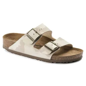 A Birkenstock Arizona sandal featuring a cork footbed and two adjustable buckled straps in a light camouflage pattern.