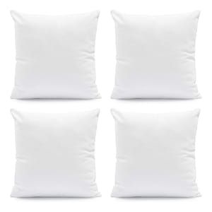 Set of four plain white square pillows.