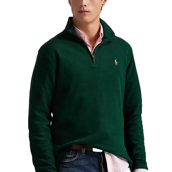 Forest green Polo Ralph Lauren 1/4-zip pullover featuring long sleeves, a high collar, and the signature logo embroidered on the chest; styled over a pink shirt with jeans.