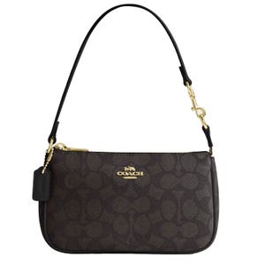 The Coach Outlet Nolita 19 Bag features a dark signature canvas with a gold-tone logo, a detachable leather strap, and a zip-top closure, accented with gold hardware.