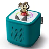 A teal Toniebox audio player with a dog figurine on top, designed for children to play stories and songs interactively.