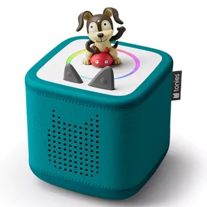 A teal Toniebox audio player with a dog figurine on top, designed for children to play stories and songs interactively.