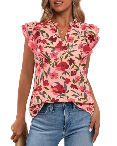A woman wears a floral blouse with ruffled sleeves, featuring a pink background and red flowers, paired with blue jeans.