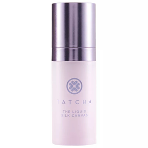 Tatcha The Liquid Silk Canvas is a priming serum with a sleek bottle design, featuring a purple cap and brand logo.