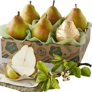 A box of five pears, with one wrapped in gold foil, is accompanied by sliced pear pieces and green branches with small white flowers.