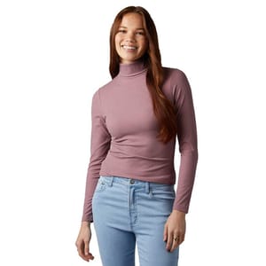 A person is wearing a long-sleeve, mauve turtleneck top paired with light blue jeans.