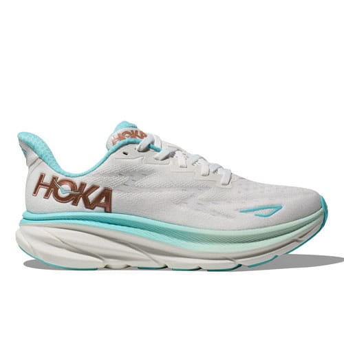 Hoka Women's Clifton 9 Shoes feature a white body with teal accents and a prominent brown Hoka logo. They have a cushioned sole designed for comfort and support.