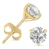A pair of gold stud earrings featuring a round-cut diamond set in a four-prong setting.
