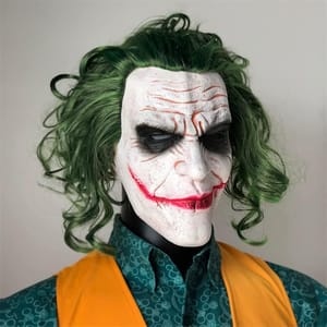 This is a latex mask styled after the Joker character, featuring green hair, white face makeup, and exaggerated red lips.