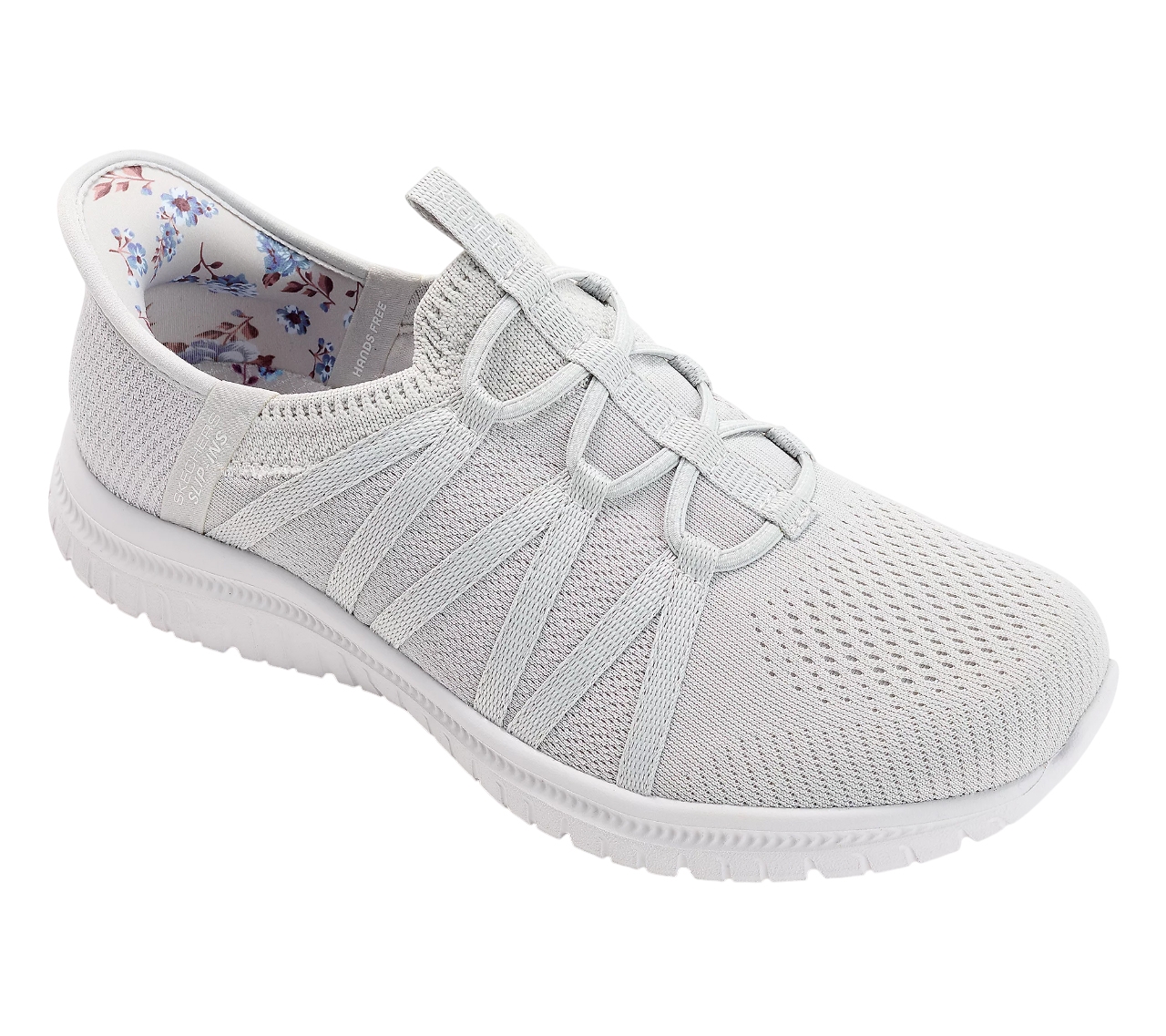 The Skechers Slip-ins Sneakers are light gray, featuring a mesh upper with elastic laces for easy slip-on access and a floral pattern on the inner lining. They have a cushioned sole for comfort and a casual design.