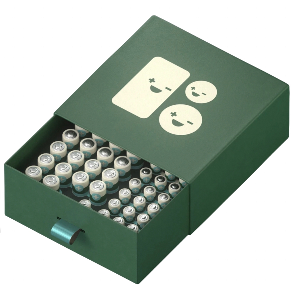 46-pack battery organizer case in dark green with a drawer containing AA and AAA batteries. The case features smiling battery faces with positive and negative signs on its lid.