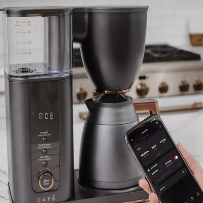 A smart coffee maker with a digital display and a smartphone app for controlling strength, temperature, and scheduling brew times.