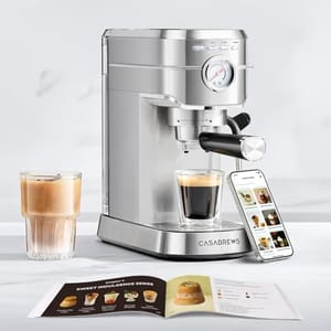 A Casabrews espresso machine with a glass of coffee, a smartphone displaying coffee recipes, and an open booklet featuring coffee options.