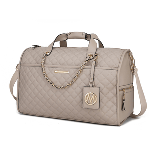 A beige quilted leather duffle bag with gold chain accents, dual handles, and an adjustable shoulder strap, featuring a decorative emblem tag and side zip pockets.