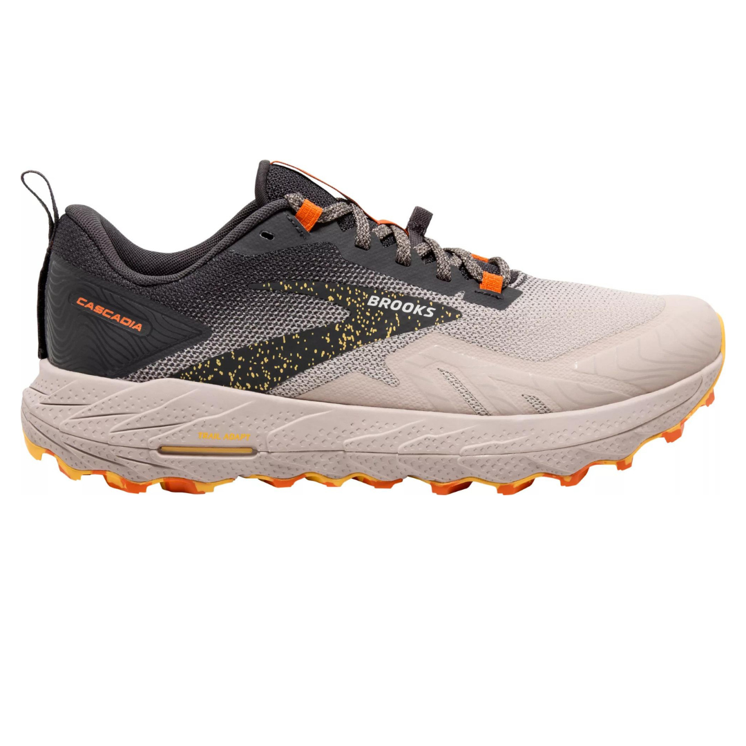 A pair of men's Brooks Cascadia 17 trail shoes with a grey and white upper, orange accents, and a beige sole with orange tread.