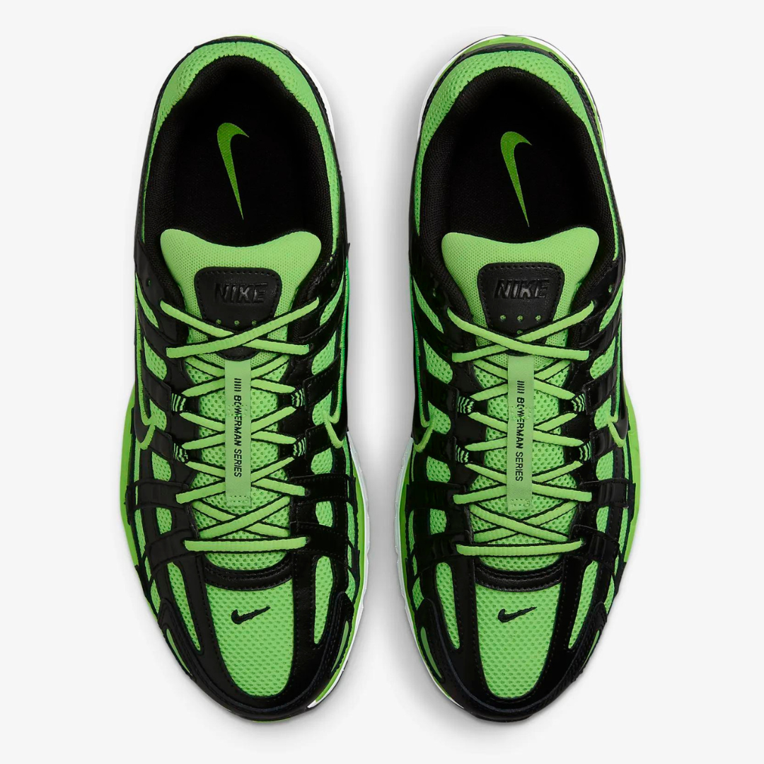 A pair of Nike P-6000 shoes in black and green with a breathable mesh upper, wavy overlays, and a classic lace-up design.