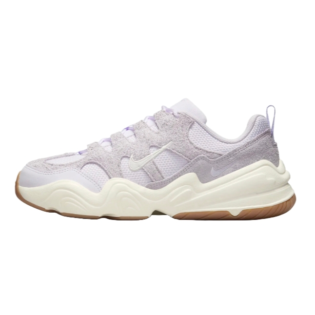 Nike Tech Hera Shoes feature a mix of light purple suede and mesh materials on the upper, with a cream-colored sculpted midsole and gum outsole, providing a stylish and cushioned design.