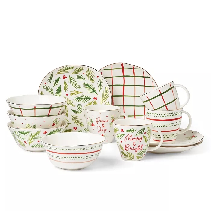 12-piece Lenox Bayberry Dessert Set features festive designs with green pine leaves, red berries, and checkered patterns; includes plates, bowls, and mugs with phrases like \“Peace & Joy\“ and \“Merry & Bright.\“