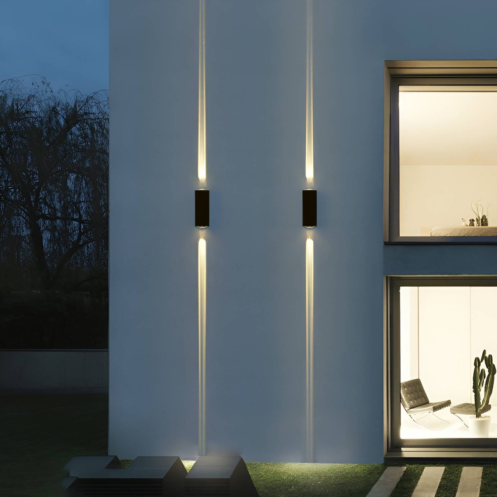 Two outdoor wall-mounted LED lights casting vertical beams on a building's facade.