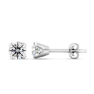 Pair of nearly 1-carat diamond stud earrings featuring round-cut stones set in a four-prong white metal setting, with butterfly backs for secure wearing.