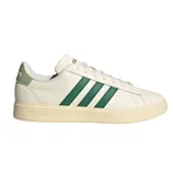 Adidas sneaker with a cream upper, green three-stripe design, and adidas branding on the heel and sole.