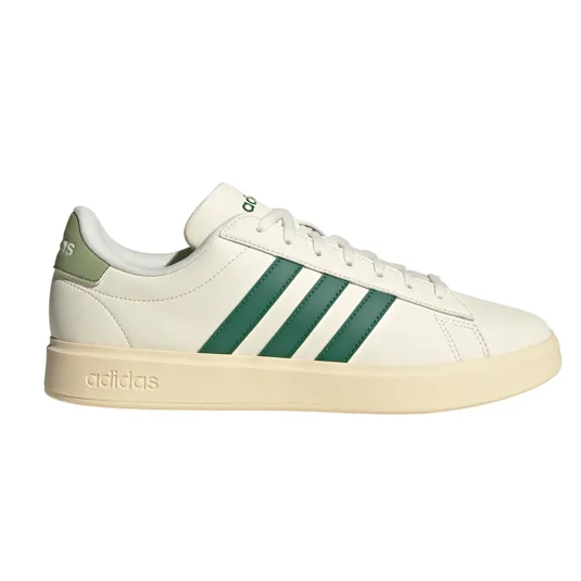 Adidas sneaker with a cream upper, green three-stripe design, and adidas branding on the heel and sole.