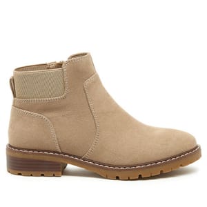 A tan ankle boot with a low block heel, featuring a suede finish, side zipper, and elastic panel for easy wear.
