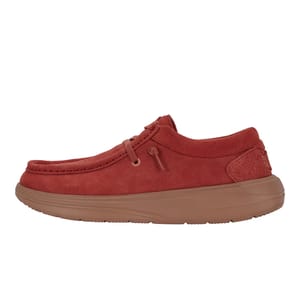 Hey Dude Wendy Comf Suede Shoes in red have a soft suede exterior with a moc toe design, lace-up front, and cushioned insole. They feature a lightweight, tan EVA sole for comfort and flexibility.