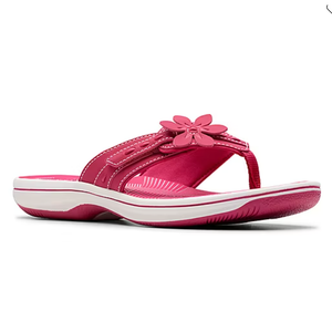 A pink sandal with white stitching and a flower decoration on the strap, featuring a white sole with pink accents.