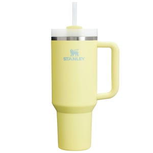 Yellow Stanley tumbler mug with a handle and straw.