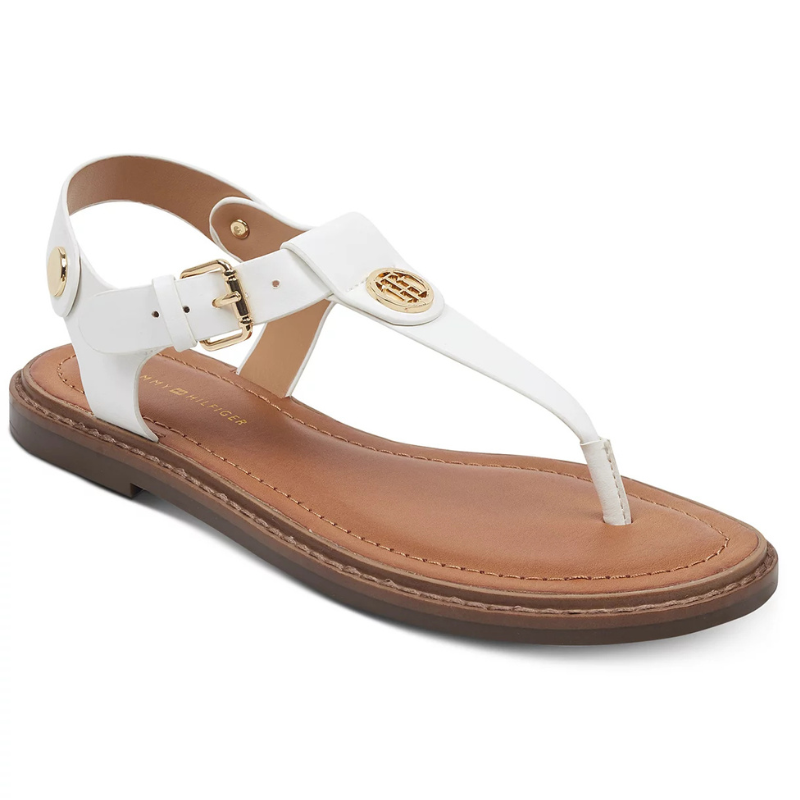 White thong sandal with a brown sole, adjustable ankle strap, and gold logo detailing.