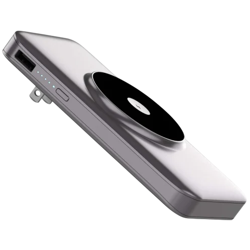 A sleek, portable power bank with a USB port and a black circular wireless charging pad on its surface, featuring LED indicators for power level and a built-in plug for charging.
