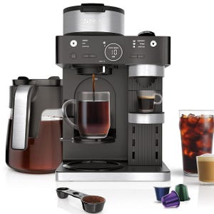 The Refurb Ninja Coffee Barista System is a versatile coffee machine that supports classic, rich, over-ice, and espresso brews. It includes a carafe, cups, and options for using ground coffee or pods, offering multiple brewing sizes and settings.