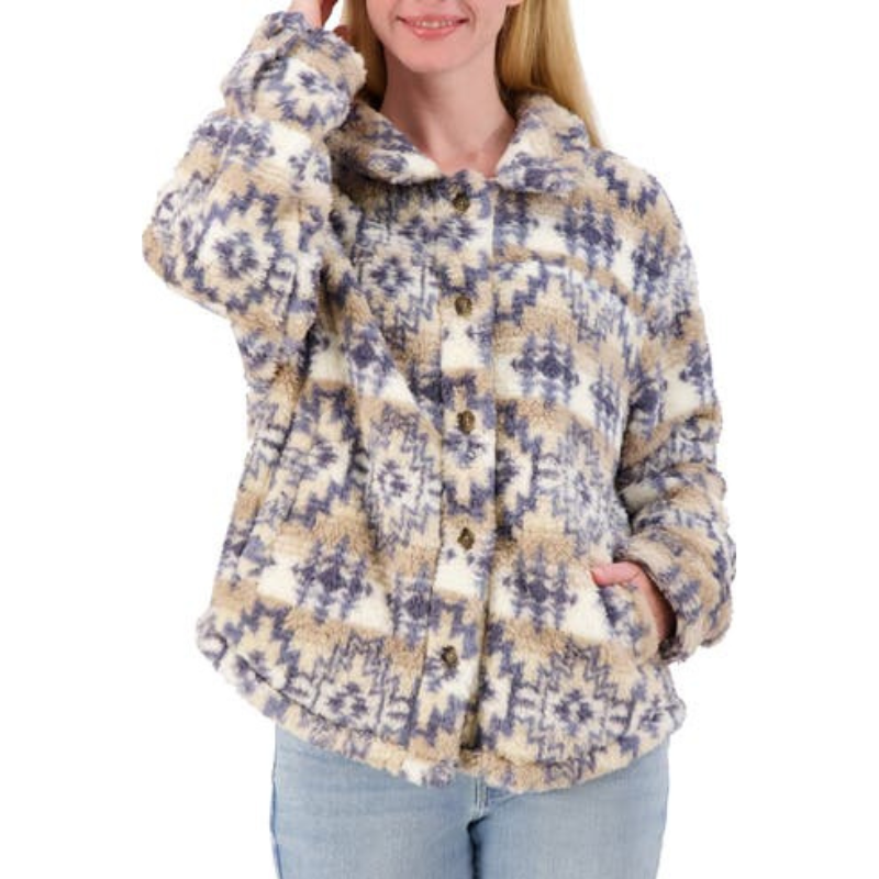 A cozy, high-pile fleece shacket with a geometric pattern in beige, blue, and white, featuring a button-up front and a relaxed fit, worn with light blue jeans.