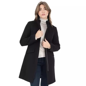 A stylish black Nine West winter coat featuring a high collar, full-length front zipper, and flap pockets, paired with a light turtleneck sweater and jeans.