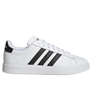 A white Adidas sneaker featuring black stripes and a low-top design with a lace-up closure. The branding is visible on the heel and tongue.