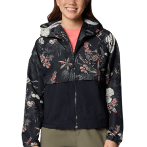 A woman is wearing a black floral-patterned hooded jacket with a zipper front and a pink shirt underneath. The jacket features a mix of white, pink, and red floral designs.