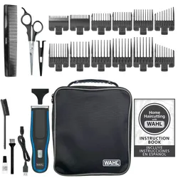 Wahl hair cutting kit with clippers, multiple guide combs, scissors, comb, cleaning brush, oil, USB charging cable, storage case, and instruction book with Spanish guide.