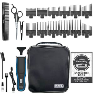Wahl hair cutting kit with clippers, multiple guide combs, scissors, comb, cleaning brush, oil, USB charging cable, storage case, and instruction book with Spanish guide.
