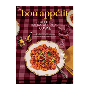 Bon Appétit magazine cover featuring a tribute to Italian American cuisine, showcasing a dish of pasta with bolognese sauce on a checkered tablecloth, accompanied by a glass of red wine.