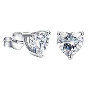 Heart-shaped diamond stud earrings set in a silver-tone metal setting.