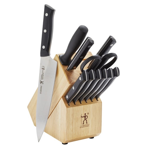 Zwilling 12-piece knife block set includes a chef's knife, paring knife, bread knife, utility knife, six steak knives, kitchen shears, honing steel, all housed in a wooden block with black handles and silver rivets.