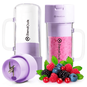 Portable blender with detachable cups, one empty and one filled with a pink berry smoothie, alongside fresh berries.