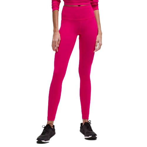 A person is wearing bright pink high-waisted leggings with black sneakers and a matching long-sleeve top.