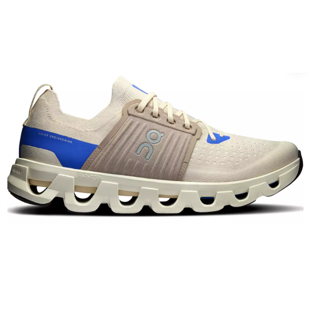 Running shoe with beige and blue accents, featuring a distinctive CloudTec sole for cushioning and stability.