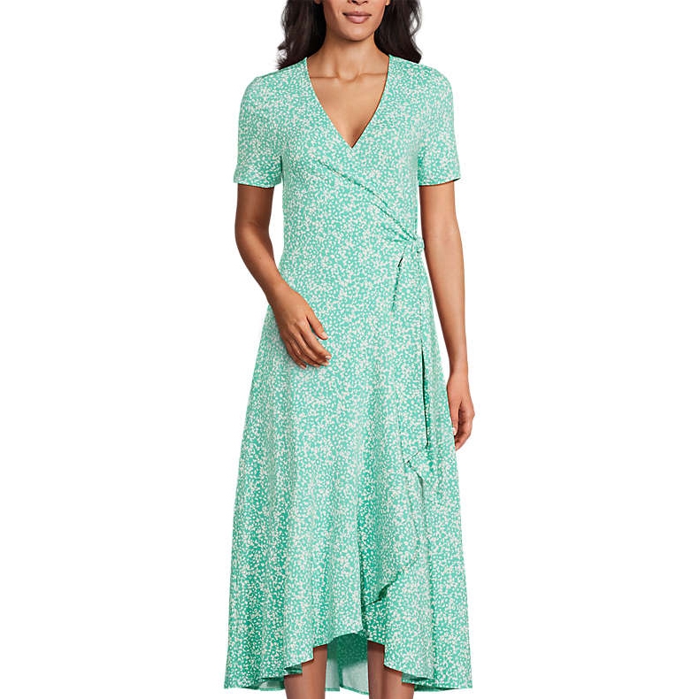A green wrap dress with white floral patterns, featuring short sleeves and a V-neckline.