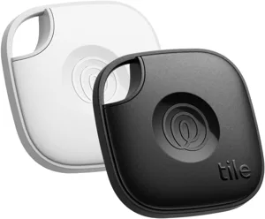 Two Tile Mate Bluetooth trackers, one black and one white, designed for finding lost items using a connected mobile app.