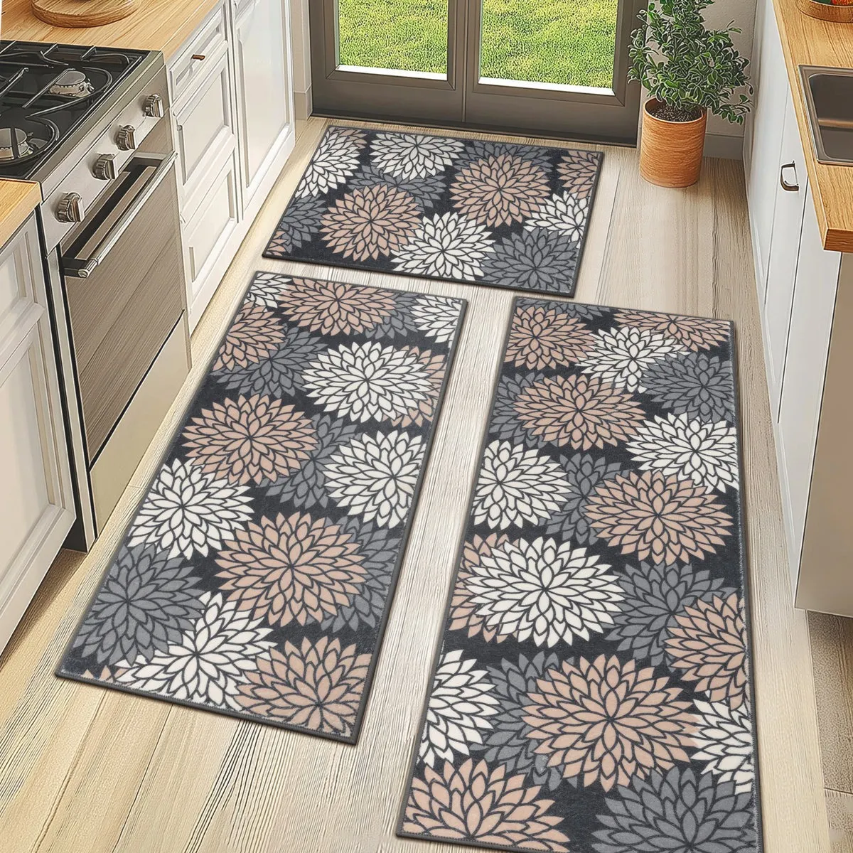 Three geometric-patterned kitchen mats feature a floral design with shades of white, beige, and gray against a dark background, placed on a light wood floor.